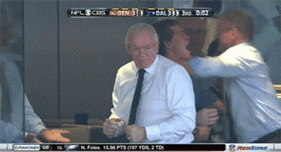 A Man In A White Shirt And Tie Is Dancing In Front Of A Screen That Says Nfl Cubs GIF