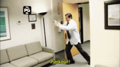A Man In A White Shirt And Tie Is Doing A Parkour GIF