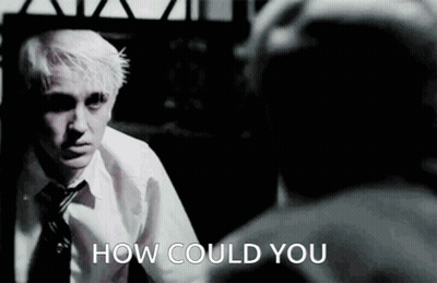 A Man In A White Shirt And Tie Is Looking At Himself In A Mirror And The Words How Could You Are Below Him GIF