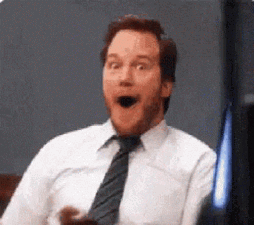 A Man In A White Shirt And Tie Is Making A Funny Face . GIF