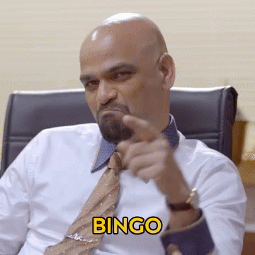 A Man In A White Shirt And Tie Is Pointing At The Camera With The Word Bingo In Yellow GIF