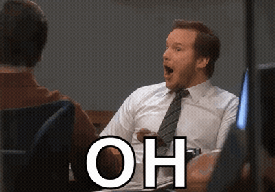 A Man In A White Shirt And Tie Is Sitting At A Desk With His Mouth Open And The Word Oh Written Below Him GIF