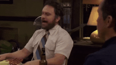 A Man In A White Shirt And Tie Is Sitting At A Table GIF