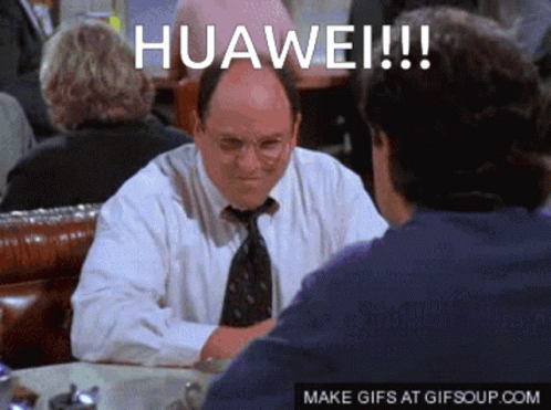 A Man In A White Shirt And Tie Is Sitting At A Table Talking To Another Man With The Words Huawei Written On The Screen GIF