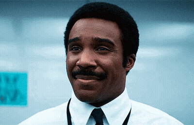 A Man In A White Shirt And Tie Is Smiling . GIF
