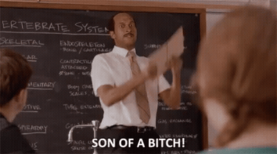 A Man In A White Shirt And Tie Is Standing In Front Of A Blackboard And Holding A Piece Of Paper In Front Of Him . GIF