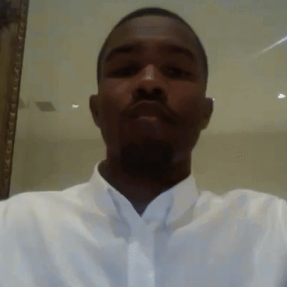 A Man In A White Shirt And Tie Is Taking A Selfie . GIF