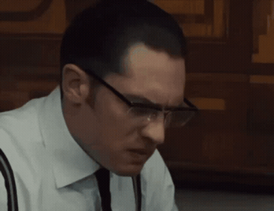 A Man In A White Shirt And Tie Sits At A Table With A Plate Of Food GIF