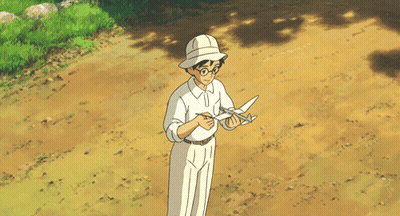 A Man In A White Shirt And White Pants Is Standing On A Dirt Road GIF