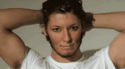 A Man In A White Shirt Has His Hands On His Head GIF