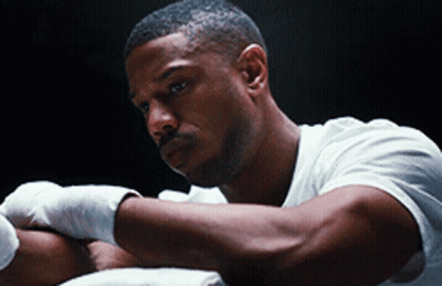 A Man In A White Shirt Has His Hands Wrapped In Bandages GIF