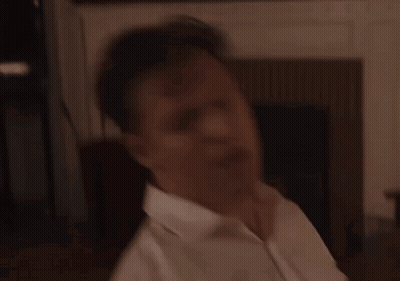A Man In A White Shirt Holds A Microphone In His Hand GIF
