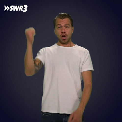A Man In A White Shirt Holds His Fist Up In Front Of A Blue Background With Swr3 Written On It GIF