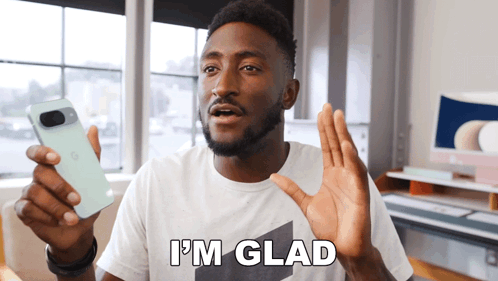 A Man In A White Shirt Holds Up A Cell Phone And Says I 'M Glad GIF