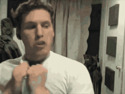 A Man In A White Shirt Is Adjusting His Bow Tie GIF