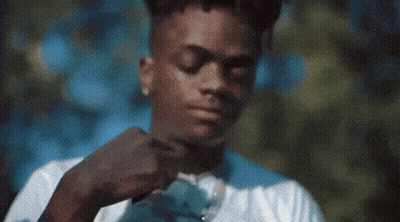 A Man In A White Shirt Is Adjusting His Tie . GIF