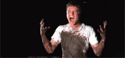 A Man In A White Shirt Is Covered In Mud And Has His Mouth Open GIF