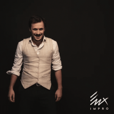 A Man In A White Shirt Is Dancing In Front Of A Black Background With The Word Impro On It GIF