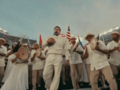 A Man In A White Shirt Is Dancing In Front Of A Crowd GIF