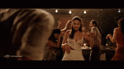 A Man In A White Shirt Is Dancing With A Woman In A Dark Room With A Youtube Logo On The Bottom GIF