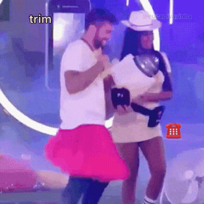 A Man In A White Shirt Is Dancing With A Woman In A Pink Skirt And The Word Trim Is On The Bottom GIF