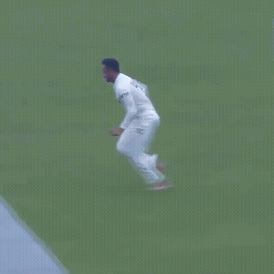 A Man In A White Shirt Is Doing Push Ups In The Ocean . GIF