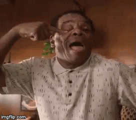 A Man In A White Shirt Is Flexing His Muscles And Yawning . GIF
