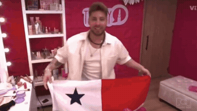 A Man In A White Shirt Is Holding A Flag With A Blue Star On It GIF