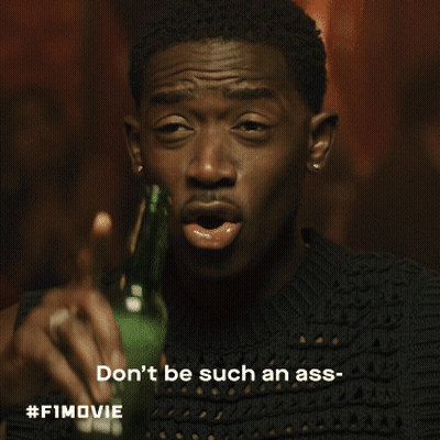 A Man In A White Shirt Is Holding A Glass And Says Dickhead GIF