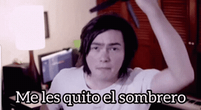 A Man In A White Shirt Is Holding A Knife Over His Head With The Words Me Les Quito El Sombrero Above Him GIF