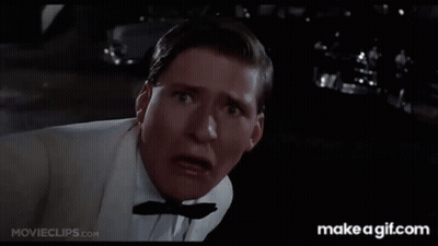 A Man In A White Shirt Is Holding His Fist Up And Says Why You Lucky Son Of GIF