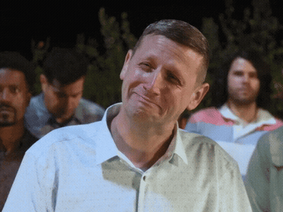 A Man In A White Shirt Is Making A Face GIF