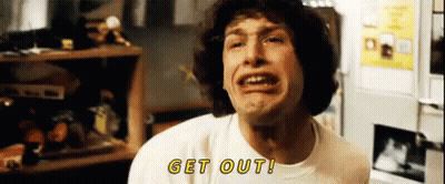 A Man In A White Shirt Is Making A Funny Face And Says Get Out . GIF