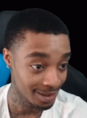 A Man In A White Shirt Is Making A Funny Face . GIF