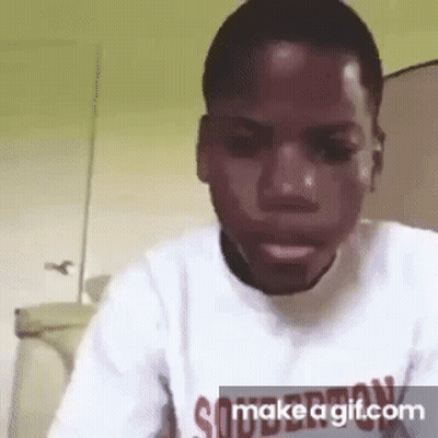 A Man In A White Shirt Is Making A Funny Face While Looking At The Camera . GIF