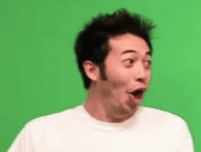 A Man In A White Shirt Is Making A Surprised Face . GIF