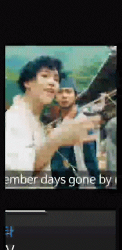 A Man In A White Shirt Is Pointing At Something In A Video That Says ' Amber Days Gone By ' GIF