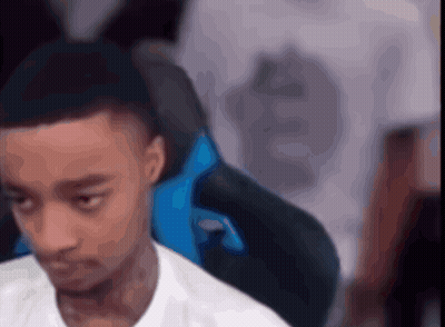 A Man In A White Shirt Is Sitting In A Blue Chair With His Eyes Closed GIF