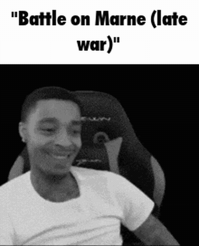 A Man In A White Shirt Is Sitting In A Chair And Smiling . GIF