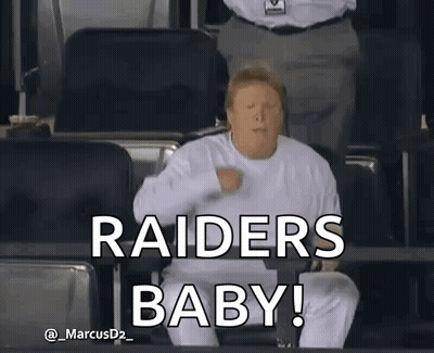 A Man In A White Shirt Is Sitting In A Stadium And Says " Raiders Baby " . GIF
