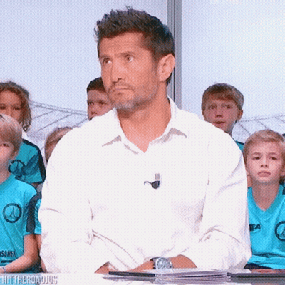 A Man In A White Shirt Is Sitting In Front Of A Group Of Children Wearing Blue Shirts That Say ' Ea ' GIF