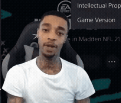 A Man In A White Shirt Is Sitting In Front Of A Screen That Says Intellectual Prop Game Version GIF