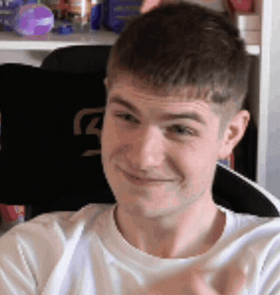 A Man In A White Shirt Is Smiling And Clapping His Hands . GIF