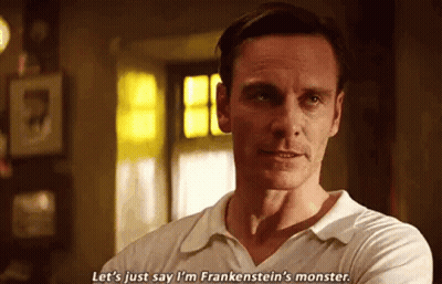 A Man In A White Shirt Is Standing In A Room With His Arms Crossed . GIF
