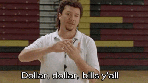A Man In A White Shirt Is Standing In Front Of A Basketball Court And Making A Hand Gesture . GIF
