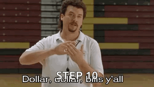 A Man In A White Shirt Is Standing In Front Of A Bleacher And Making A Gesture With His Hands . GIF