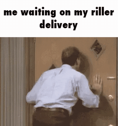 A Man In A White Shirt Is Standing In Front Of A Door Waiting For A Delivery . GIF