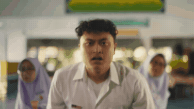 A Man In A White Shirt Is Standing In Front Of A Sign That Says ' A ' On It GIF