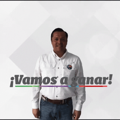 A Man In A White Shirt Is Standing In Front Of A Sign That Says " Vamos A Ganar " GIF