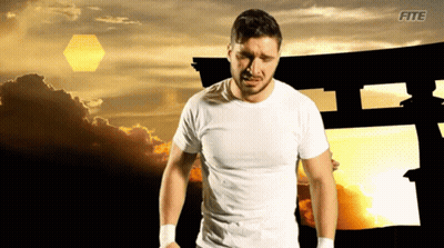 A Man In A White Shirt Is Standing In Front Of A Sunset With The Word Fite On The Bottom Left GIF